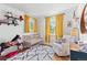 Cozy Bedroom with bright yellow curtains, crib, rocker, and playful decor at 7888 S Magnolia Way, Centennial, CO 80112