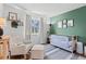 Charming Bedroom featuring neutral tones, playful decor, and a comfortable rocking chair at 7888 S Magnolia Way, Centennial, CO 80112