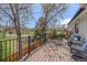 Inviting deck with black railing and wicker furniture overlooks a beautifully landscaped backyard at 7888 S Magnolia Way, Centennial, CO 80112