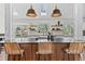 Kitchen island with pendant lights, bar seating, and hardwood accents creates a stylish and functional space at 7888 S Magnolia Way, Centennial, CO 80112