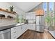 Bright kitchen with stainless steel appliances, dark countertops, hardwood floors, and white subway tile backsplash at 7888 S Magnolia Way, Centennial, CO 80112