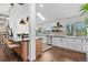 Bright kitchen featuring stainless steel appliances, white cabinetry, and an island with bar seating at 7888 S Magnolia Way, Centennial, CO 80112