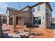 Backyard stone patio with seating area and string lights, perfect for outdoor entertaining at 1150 Maddox Ct, Broomfield, CO 80023