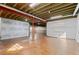 Unfinished basement with exposed beams, cement floor, and lighting fixtures at 1150 Maddox Ct, Broomfield, CO 80023