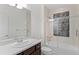 Bathroom with modern vanity, a glass enclosed tub, and tiled walls at 1150 Maddox Ct, Broomfield, CO 80023