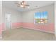 Bright bedroom featuring a chair rail, neutral carpet, a ceiling fan and ample natural light at 1150 Maddox Ct, Broomfield, CO 80023