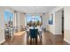 Bright dining room featuring large windows, stylish lighting, hardwood floors, and an elegant dining set at 1150 Maddox Ct, Broomfield, CO 80023