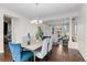 Dining area with hardwood floors, chandelier, and an open view to the living spaces with large windows at 1150 Maddox Ct, Broomfield, CO 80023