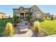 Inviting two-story home with manicured lawn, stone accents, and a charming walkway to the front door at 1150 Maddox Ct, Broomfield, CO 80023