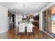 Open-concept kitchen with dark wood cabinets, stainless steel appliances, and a dining area at 1150 Maddox Ct, Broomfield, CO 80023