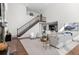 Spacious living room featuring a staircase, hardwood floors, high ceilings, and an open layout at 1150 Maddox Ct, Broomfield, CO 80023