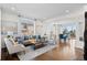 Inviting living room with hardwood floors, large windows, stylish furniture, and an open view to the dining area at 1150 Maddox Ct, Broomfield, CO 80023