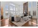 Bright living room featuring soaring ceilings, large windows, a stone fireplace, and modern furnishings at 1150 Maddox Ct, Broomfield, CO 80023