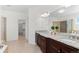 Bright main bathroom with double vanity, granite countertop, large mirror, and glass enclosed shower at 1150 Maddox Ct, Broomfield, CO 80023