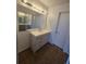 A well lit bathroom features a large mirror, neutral paint, and modern vanity at 6009 Yarrow St # C, Arvada, CO 80004