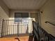 Front entrance showing real estate signs in the window, along with the unit's front door and stairs at 6009 Yarrow St # C, Arvada, CO 80004