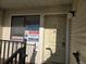 Front entryway with 'Coming Soon' and 'For Sale' signs posted next to the front door and window at 6009 Yarrow St # C, Arvada, CO 80004
