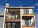 Two-story condo with private balconies and stairwell access to front door, featuring a neutral color scheme at 6009 Yarrow St # C, Arvada, CO 80004