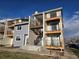 Apartment complex showcasing unit exteriors, landscaping, and convenient walkway to each unit at 6009 Yarrow St # C, Arvada, CO 80004
