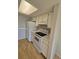 Well-lit kitchen featuring white cabinets, appliances, and neutral countertops at 6009 Yarrow St # C, Arvada, CO 80004