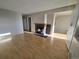 Spacious living room with light hardwood floors and fireplace, leading to other rooms at 6009 Yarrow St # C, Arvada, CO 80004