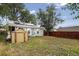 Backyard with shed, privacy fence, lawn, and mature trees at 1448 Depew St, Lakewood, CO 80214