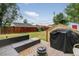 Spacious backyard with a patio seating area, fire pit, and well-maintained lawn at 1448 Depew St, Lakewood, CO 80214