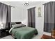 Comfortable bedroom with a queen bed, soft grey rug, and modern black accents at 1448 Depew St, Lakewood, CO 80214