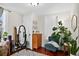 Bright bedroom with decorative mirror, dresser, chair and indoor plants at 1448 Depew St, Lakewood, CO 80214