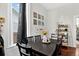 Cozy dining area featuring a dark wood table, comfortable seating, and natural light from the window at 1448 Depew St, Lakewood, CO 80214
