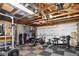 Spacious garage equipped with home gym, exposed rafters, and garage door at 1448 Depew St, Lakewood, CO 80214