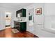 Cozy kitchen featuring dark green cabinets, tile countertops, and stainless steel faucet at 1448 Depew St, Lakewood, CO 80214
