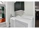 Laundry room with modern white washer and dryer, and dark green cabinets at 1448 Depew St, Lakewood, CO 80214