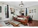 Inviting living room with hardwood floors, leather sofa, large windows, and stylish decor at 1448 Depew St, Lakewood, CO 80214