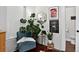 Cozy living room with blue chair, monstera plant, and framed art at 1448 Depew St, Lakewood, CO 80214