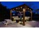 Outdoor living space with a covered patio featuring a seating area, fire pit, and string lights for cozy evenings at 6092 S Ouray St, Aurora, CO 80016