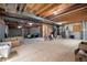 Unfinished basement featuring exposed duct work, concrete walls, a support beam, and plywood flooring, ready for customization at 6092 S Ouray St, Aurora, CO 80016