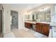 Bathroom featuring double vanity sinks, tiled floors, and neutral walls creating a clean and refreshing space at 6092 S Ouray St, Aurora, CO 80016