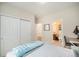 Bright bedroom featuring a desk, neutral walls, and a closet leading to a private bathroom for ultimate convenience at 6092 S Ouray St, Aurora, CO 80016