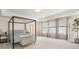 Sunlit bedroom with a king bed, neutral carpet, and large windows creating a bright and comfortable living space at 6092 S Ouray St, Aurora, CO 80016