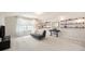 Bright bonus room featuring neutral carpet, shelves, and a comfortable seating area perfect for relaxation or entertainment at 6092 S Ouray St, Aurora, CO 80016