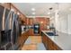 Spacious kitchen features stainless steel appliances, wooden cabinets, and gray countertops at 6092 S Ouray St, Aurora, CO 80016