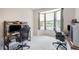 Spacious home office featuring dual workstations, ergonomic chairs, and lots of natural light from large windows at 6092 S Ouray St, Aurora, CO 80016