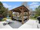 This outdoor patio features a cozy pergola with seating, perfect for relaxing or entertaining guests on sunny afternoons at 6092 S Ouray St, Aurora, CO 80016