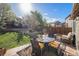 Inviting backyard patio with an outdoor dining set and lush landscaping at 10359 Tracewood Dr, Highlands Ranch, CO 80130