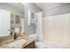 Well-lit bathroom featuring a shower/tub combo, granite countertop, and modern fixtures at 10359 Tracewood Dr, Highlands Ranch, CO 80130