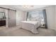 Bedroom featuring a modern barn door leading to ensuite bathroom and neutral furnishings at 10359 Tracewood Dr, Highlands Ranch, CO 80130