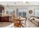 Bright kitchen with dining area, tile floors, modern appliances, and backyard view at 10359 Tracewood Dr, Highlands Ranch, CO 80130