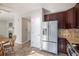 Modern kitchen with stainless steel refrigerator and view into adjacent living area at 10359 Tracewood Dr, Highlands Ranch, CO 80130