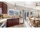 Updated kitchen with stainless steel appliances, granite counters, tile backsplash, and sliding glass door at 10359 Tracewood Dr, Highlands Ranch, CO 80130
